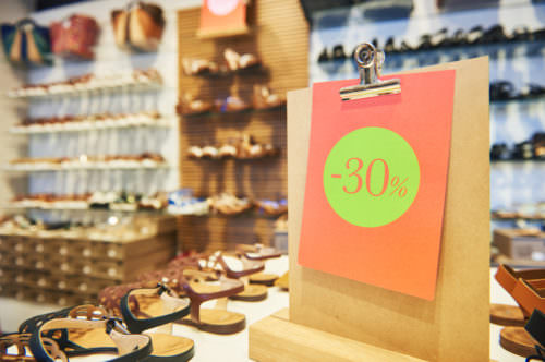 Shopping sale. seasonal price discount on footwear in shoe shop store